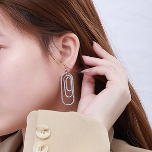 Silver stainless steel triple oval drop earrings with cable texture shown on model