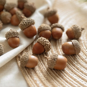 Natural decorative acorns on linen fabric for rustic Christmas and autumn home decor setups