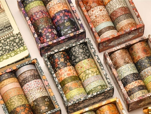 Close-up of vintage floral washi tape rolls with elegant botanical patterns for scrapbooking
