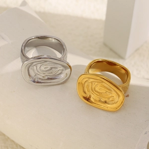 Detail showing irregular molten texture on gold and silver minimalist metal rings