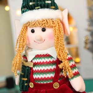 Detail of Christmas elf doll with sequin hat and red green striped festive outfit