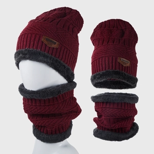 Detailed close-up of chunky knit pattern and grey faux fur lining on burgundy winter set