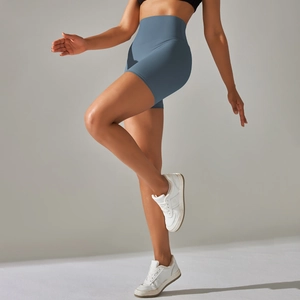 Detail of high-waist yoga shorts in dusty blue showing stretch and body-shaping fit