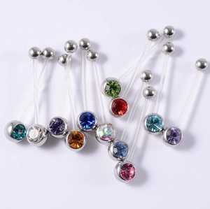 Macro detail of flexible acrylic belly rings featuring colorful sparkling rhinestones
