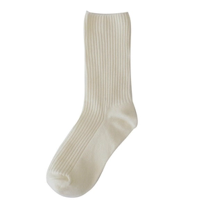 Detailed view of off-white mid-calf socks featuring a premium ribbed knit cotton texture