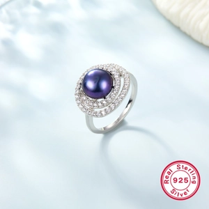Detailed close-up of a large purple pearl ring with double zircon halo in 925 silver