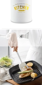 White silicone slotted turner with wooden handle for non-stick cooking and storage bucket