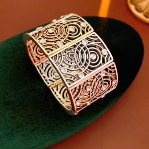 Macro view of vintage tri-color elastic bracelet with hollow swirl patterns and crystals