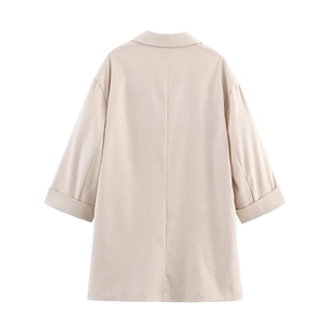 Détail d'un blazer en lin beige à double boutonnage montrant l'épaule et la texture du tissu