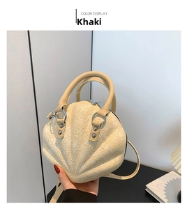 Detail of khaki shell bag featuring 3D floral lace texture and silver hardware accents