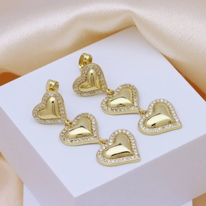 18k gold plated heart drop earrings with sparkling zircon stones on a pedestal