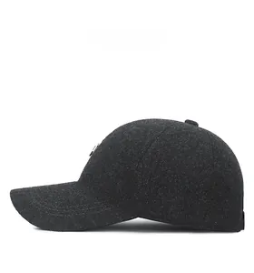 Side view of dark grey wool blend baseball cap with ear protection and detailed stitching