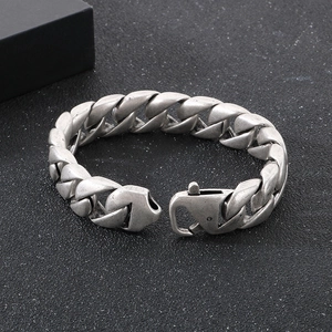 Macro shot of 15mm vintage silver Cuban link bracelet with spring clasp on black background