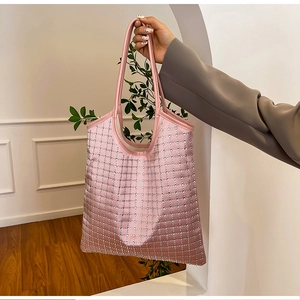 Detail view of pink tote bag featuring sparkling silver rhinestone grid patterns on fabric