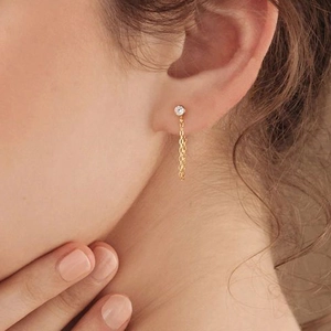 Minimalist gold stainless steel tassel chain earrings with round crystal on female model