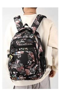 Rear view of a model wearing the black football-themed backpack with white graphic prints