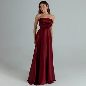 Detail of elegant burgundy satin evening dress showing draped pleats on the strapless bodice