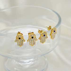 Golden Hamsa Hand stud earrings with sparkling white crystals and blue evil eye charms