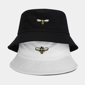 Classic cotton bucket hats in black and white featuring detailed bee embroidery