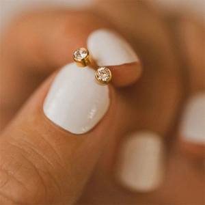 Minimalist gold-plated stainless steel stud earrings with clear round-cut rhinestones