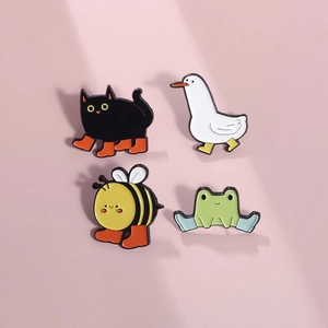 Set of four cartoon animal enamel pins featuring a black cat, duck, bee, and frog in boots