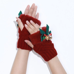 Detail of burgundy Christmas half-finger gloves with green bow and gold bell accents