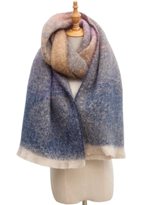 Detail of blue and orange jacquard scarf featuring fringe edges and textured knit fabric