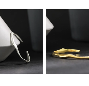 Close-up of S925 sterling silver stamp on minimalist irregular wavy surface bracelets
