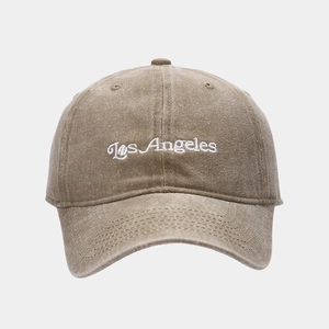 Detail of Los Angeles embroidery on khaki cotton baseball cap with reinforced stitching