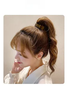 Detail of matte textured high ponytail clip with non-slip ridges on brown hair