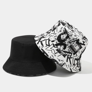 Detail view of reversible bucket hats set in plain black and graffiti print styles