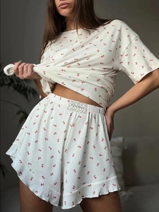 Detail shot of floral knit loungewear shorts featuring ruffle hem and elastic waistband