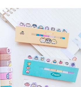 Flat lay of cute cartoon cat and fruit themed sticky notes and index tabs on paper