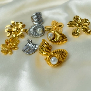 18K gold plated stainless steel pearl flower earrings collection on white silk