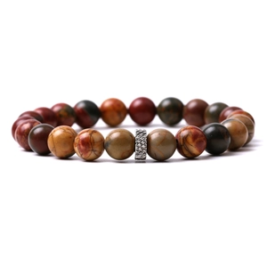 Detail view of tiger eye and lava stone beads with a carved silver spacer bead