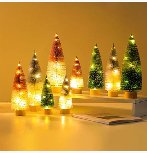 Close-up of mini sisal Christmas trees with LED warm lights on wooden bases