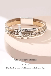 Detail of multi-layer leather bracelet featuring a silver BLESSED cross charm and magnetic clasp
