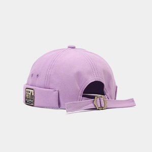 Detail of light purple canvas miki hat featuring metal adjustment buckle and side patch