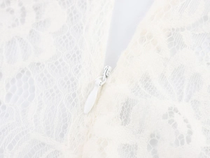 Close-up of elegant white floral lace texture and seamless invisible zipper detail
