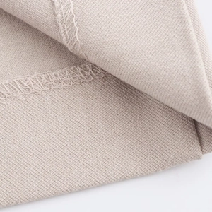 Macro view showing high-quality beige linen fabric texture and durable overlock stitching