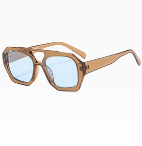 Detail of blue lenses and hexagonal brown frame with double bridge on sunglasses