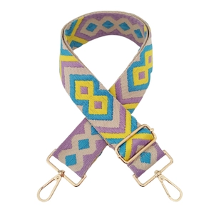 Detail of 5cm wide jacquard strap with purple geometric pattern and gold metal hooks