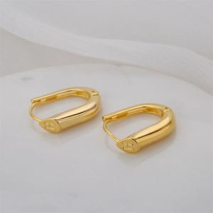 Minimalist copper 14K gold-plated U-shaped earrings with H engraving on white marble