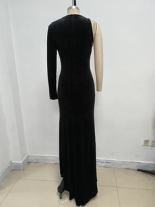 Detail of velvet fishtail dress featuring asymmetric neckline and white bow accent