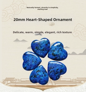 Macro shot of 20mm heart-shaped blue lapis lazuli stone with natural dark textures
