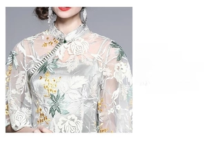 Close-up of retro cheongsam dress featuring exquisite rose embroidery and traditional knot
