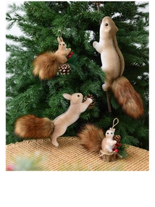 Set of four realistic furry squirrel ornaments with pine cones on a Christmas tree