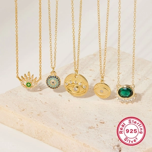 Detailed display of five 925 sterling silver evil eye pendants with zircons and gemstones
