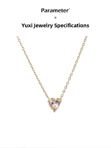 Detail of gold chain necklace featuring heart-shaped zircon pendant with parameter text