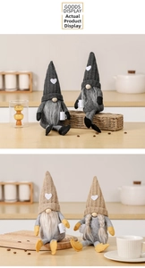 Close-up of plush gnomes with knitted heart hats and long braids for festive decoration